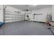 Garage with epoxy flooring, large garage door, and ample storage space at 1005 Talon Pl, Winter Springs, FL 32708