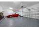 Spacious garage with epoxy flooring and a modern red sports car at 1005 Talon Pl, Winter Springs, FL 32708