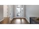 Bright hallway with wood floors leading to a room with bright french doors and stylish decor at 1005 Talon Pl, Winter Springs, FL 32708