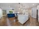 Open-concept kitchen featuring an island with seating, and view into a living room and dining area at 1005 Talon Pl, Winter Springs, FL 32708