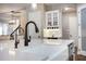 Bright kitchen island with a white farmhouse sink and modern black faucet fixtures at 1005 Talon Pl, Winter Springs, FL 32708