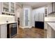 Well-designed kitchen featuring a wine fridge, stainless steel appliances, and hardwood flooring at 1005 Talon Pl, Winter Springs, FL 32708