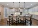 Modern kitchen with a large island, pendant lighting, white cabinetry and stainless steel appliances at 1005 Talon Pl, Winter Springs, FL 32708