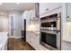 Modern kitchen featuring stainless steel appliances, white cabinets, and quartz countertops at 1005 Talon Pl, Winter Springs, FL 32708