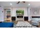 Comfortable living room featuring an electric fireplace, shiplap wall, and an open view to the bedroom at 1005 Talon Pl, Winter Springs, FL 32708