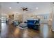 Bright living space with hardwood floors, staircase, comfortable seating, and views to the kitchen at 1005 Talon Pl, Winter Springs, FL 32708