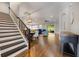 Open living space with hardwood floors, staircase, dining area, and comfortable blue couches at 1005 Talon Pl, Winter Springs, FL 32708