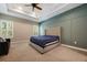 A spacious primary bedroom with a ceiling fan, plantation shutters, and an accent wall at 1005 Talon Pl, Winter Springs, FL 32708
