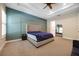 A spacious primary bedroom with a ceiling fan and an accent wall at 1005 Talon Pl, Winter Springs, FL 32708