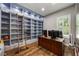Spacious office with custom built-in shelving and hardwood floors at 1005 Talon Pl, Winter Springs, FL 32708