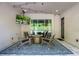 Covered patio featuring modern furniture, TV, and an outdoor fireplace for cozy gatherings at 1005 Talon Pl, Winter Springs, FL 32708
