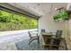 Outdoor patio with TV, modern furniture, outdoor fireplace, and retractable wall at 1005 Talon Pl, Winter Springs, FL 32708