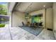 Covered patio with TV, and modern furniture; the perfect place to unwind and entertain at 1005 Talon Pl, Winter Springs, FL 32708