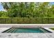 A luxurious pool with stone surround is fenced for privacy at 1005 Talon Pl, Winter Springs, FL 32708