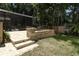 Brick patio and steps lead to a screened pool area with a mature tree line at 1101 N Division St, Oviedo, FL 32765