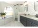 A well-appointed bathroom with soaking tub, walk-in shower, and stylish double vanity at 1101 N Division St, Oviedo, FL 32765