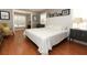 Cozy bedroom featuring a plush bed, hardwood floors, black and white photos, and natural lighting at 1101 N Division St, Oviedo, FL 32765