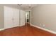 Neutral bedroom with hardwood floors, double closet, and ceiling fan at 1101 N Division St, Oviedo, FL 32765