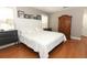 Inviting bedroom with wood floors, black-and-white photos, two nightstands, and a large wardrobe at 1101 N Division St, Oviedo, FL 32765