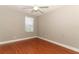 Neutral bedroom features hardwood floors and a bright window at 1101 N Division St, Oviedo, FL 32765