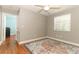 Bright bedroom with hardwood floors, ceiling fan, closet, and a sunny window at 1101 N Division St, Oviedo, FL 32765