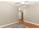 Neutral bedroom with hardwood floors, ceiling fan, and convenient closet access at 1101 N Division St, Oviedo, FL 32765