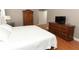 Serene bedroom features a comfy bed, hardwood floors, armoire, and a dresser with a television at 1101 N Division St, Oviedo, FL 32765