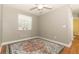 Neutral bedroom features hardwood floors, ceiling fan, and large window at 1101 N Division St, Oviedo, FL 32765