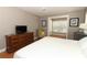 Comfortable bedroom with wood floors, dresser, television, and yellow accent chair at 1101 N Division St, Oviedo, FL 32765