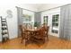 Cozy dining area with wooden table, seating for six, and French doors leading to the backyard at 1101 N Division St, Oviedo, FL 32765