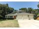 Home featuring a three-car garage and well-manicured front yard at 1101 N Division St, Oviedo, FL 32765