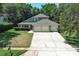 Charming two-story home featuring a three-car garage and a well-manicured lawn with mature landscaping at 1101 N Division St, Oviedo, FL 32765