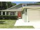 Inviting home exterior with a lush green lawn and an orange front door at 1101 N Division St, Oviedo, FL 32765