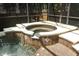 Inviting hot tub with brown tile and a white border within a screened enclosure at 1101 N Division St, Oviedo, FL 32765