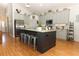 Bright kitchen boasts granite countertops, stainless appliances, and a large island with barstool seating at 1101 N Division St, Oviedo, FL 32765