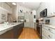 Well-lit kitchen showcasing stainless steel appliances, granite countertops, and abundant cabinet space at 1101 N Division St, Oviedo, FL 32765