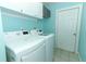 Efficient laundry room with modern washer and dryer, overhead cabinets, and a bright, clean aesthetic at 1101 N Division St, Oviedo, FL 32765