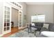 Living room with a large window and access to another room through french doors at 1101 N Division St, Oviedo, FL 32765