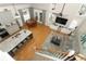 Open-concept living space with kitchen island, hardwood floors, and ample natural light at 1101 N Division St, Oviedo, FL 32765