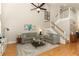 Bright living room features vaulted ceiling, ceiling fan, hardwood floors, neutral paint, and comfortable seating at 1101 N Division St, Oviedo, FL 32765
