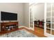 Living area with a TV, wood cabinet, and access to another room at 1101 N Division St, Oviedo, FL 32765