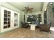 Screened-in porch features neutral brick flooring and outdoor seating at 1101 N Division St, Oviedo, FL 32765