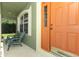 Inviting front porch with seating next to the front door at 1101 N Division St, Oviedo, FL 32765