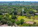 Stunning aerial view of the neighborhood, showing lush trees, waterways, and city skyline beyond at 1139 Fairway Dr, Winter Park, FL 32792