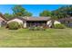 Cozy home featuring a well-maintained lawn, plants, and a screened patio, perfect for outdoor enjoyment at 1139 Fairway Dr, Winter Park, FL 32792