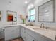 Bright bathroom featuring double sinks, quartz countertops, modern fixtures, and ample cabinet space at 1139 Fairway Dr, Winter Park, FL 32792