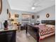 Bedroom with dark wood furnishings, ceiling fan, neutral walls, and tile flooring at 1139 Fairway Dr, Winter Park, FL 32792