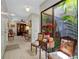 Sunlit entryway with decorative chairs, table, and atrium views from large window at 1139 Fairway Dr, Winter Park, FL 32792