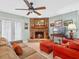 Close up of living room with stone fireplace, comfortable seating, and calming colors at 1139 Fairway Dr, Winter Park, FL 32792