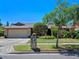 Charming home boasts a two-car garage and meticulously landscaped front yard with lush greenery at 1139 Fairway Dr, Winter Park, FL 32792